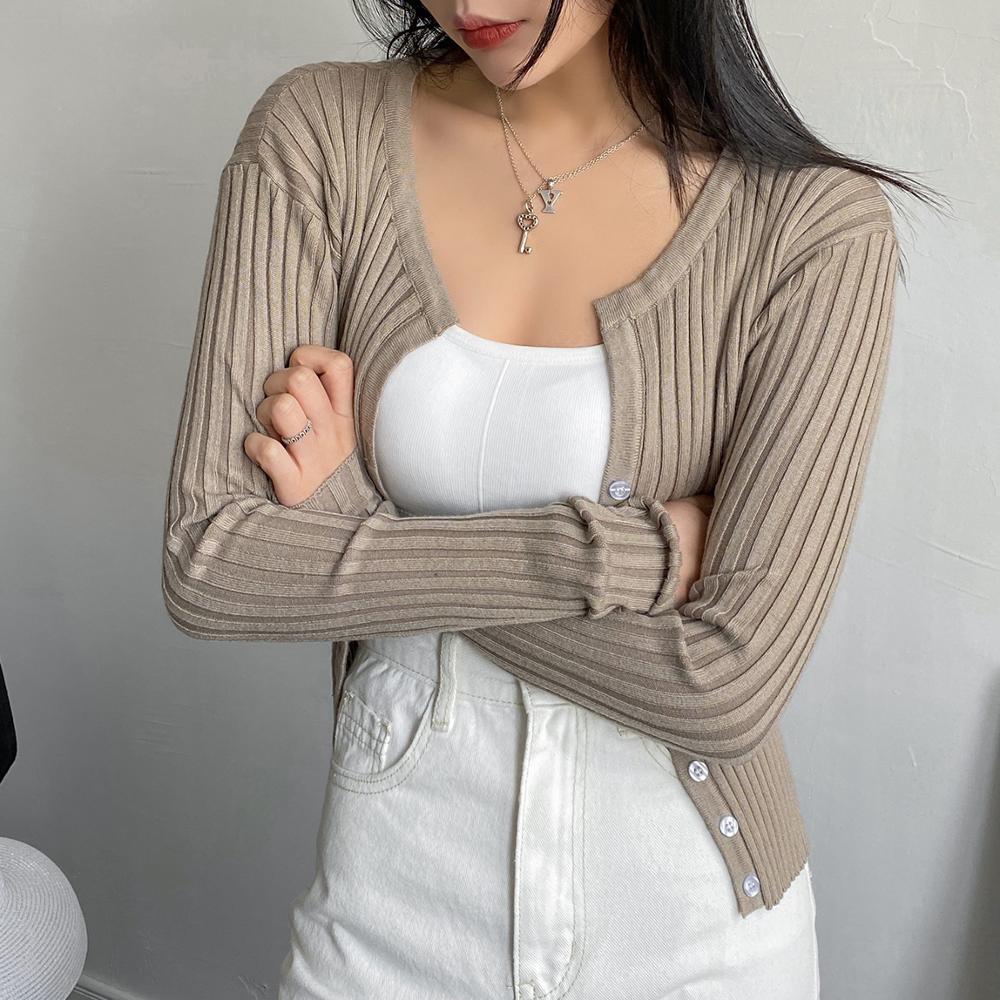 Women wearing a cropped button-up ribbed sweater shirt in a casual setting, showcasing its stylish V-neck and full-length sleeves.