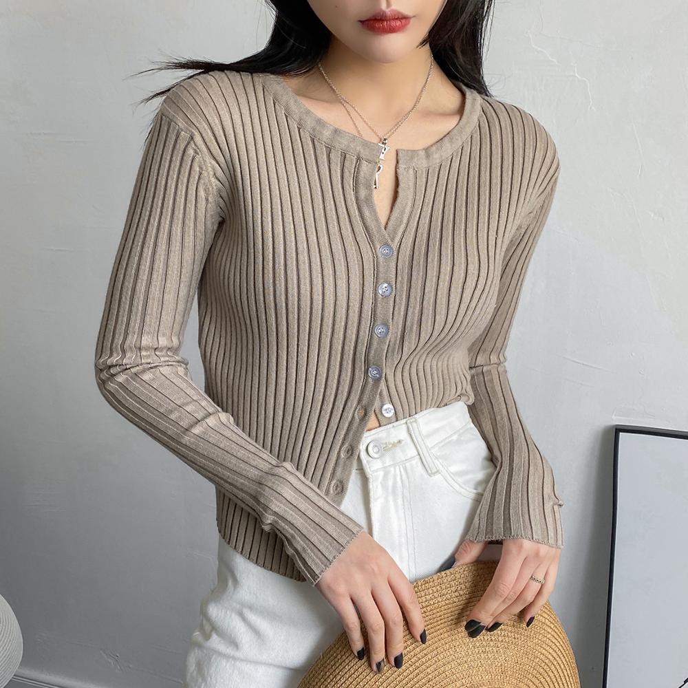 Women wearing a cropped button-up ribbed sweater shirt in a casual setting, showcasing its stylish V-neck and full-length sleeves.