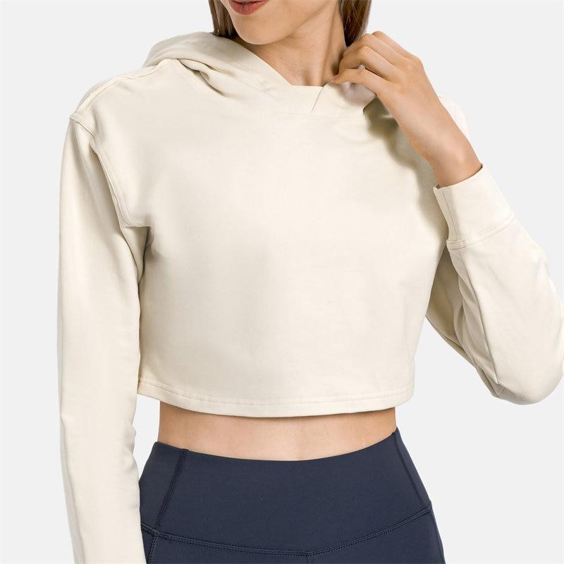 Women wearing a stylish crop hoodie with long sleeves, perfect for workouts and casual outings, showcasing a blend of comfort and fashion.