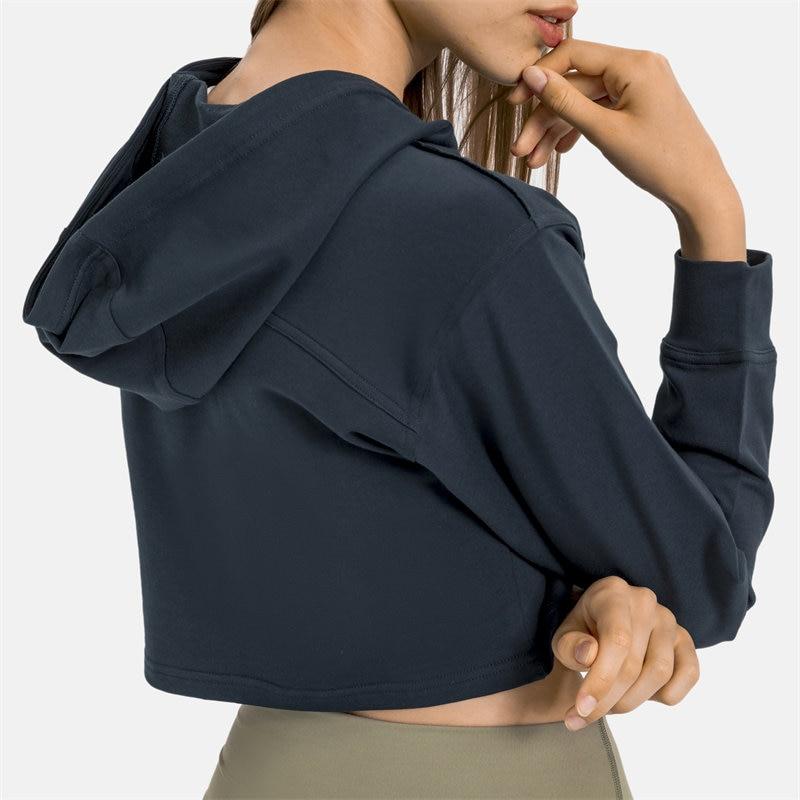 Women wearing a stylish crop hoodie with long sleeves, perfect for workouts and casual outings, showcasing a blend of comfort and fashion.