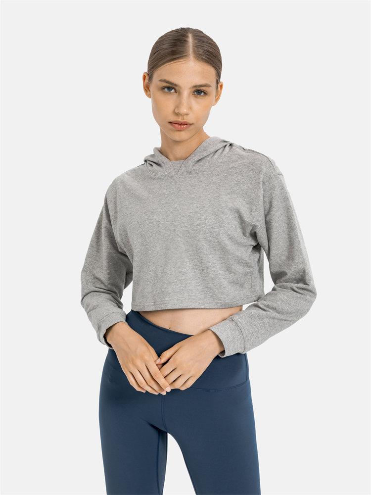 Women wearing a stylish crop hoodie with long sleeves, perfect for workouts and casual outings, showcasing a blend of comfort and fashion.