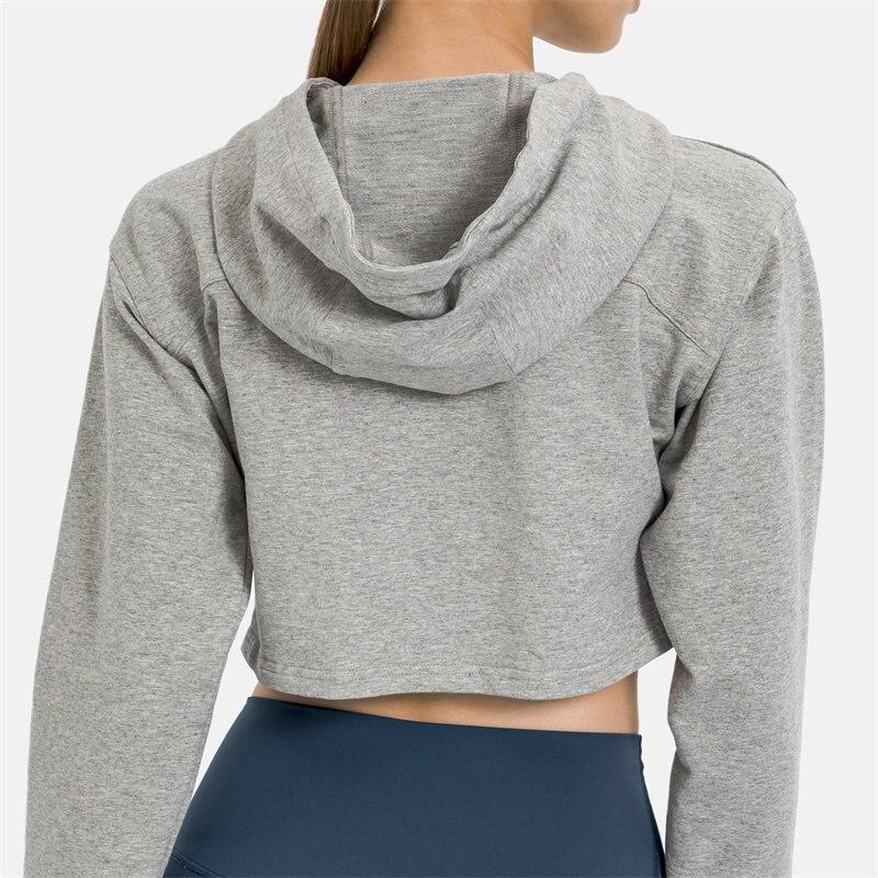 Women wearing a stylish crop hoodie with long sleeves, perfect for workouts and casual outings, showcasing a blend of comfort and fashion.