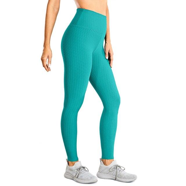 Women's high waisted compression running yoga pants with textured design and pocket, perfect for workouts.