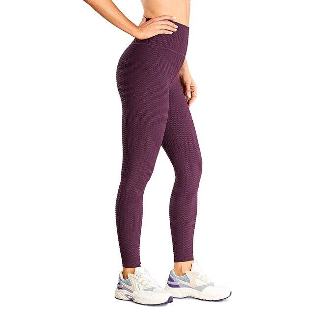 Women's high waisted compression running yoga pants with textured design and pocket, perfect for workouts.