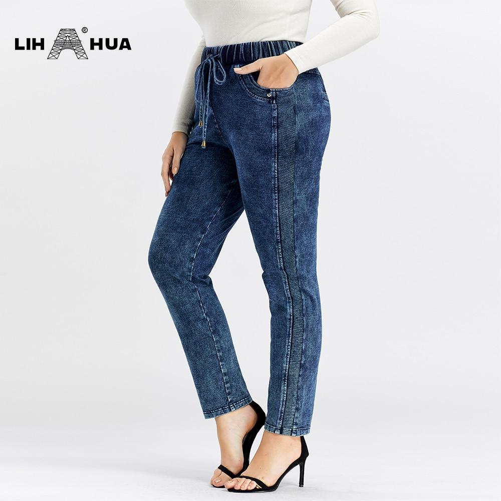 A pair of Women's Plus Size Casual Jeans featuring a mid-rise waist, full-length straight cut, and decorative sashes with lace-up details.