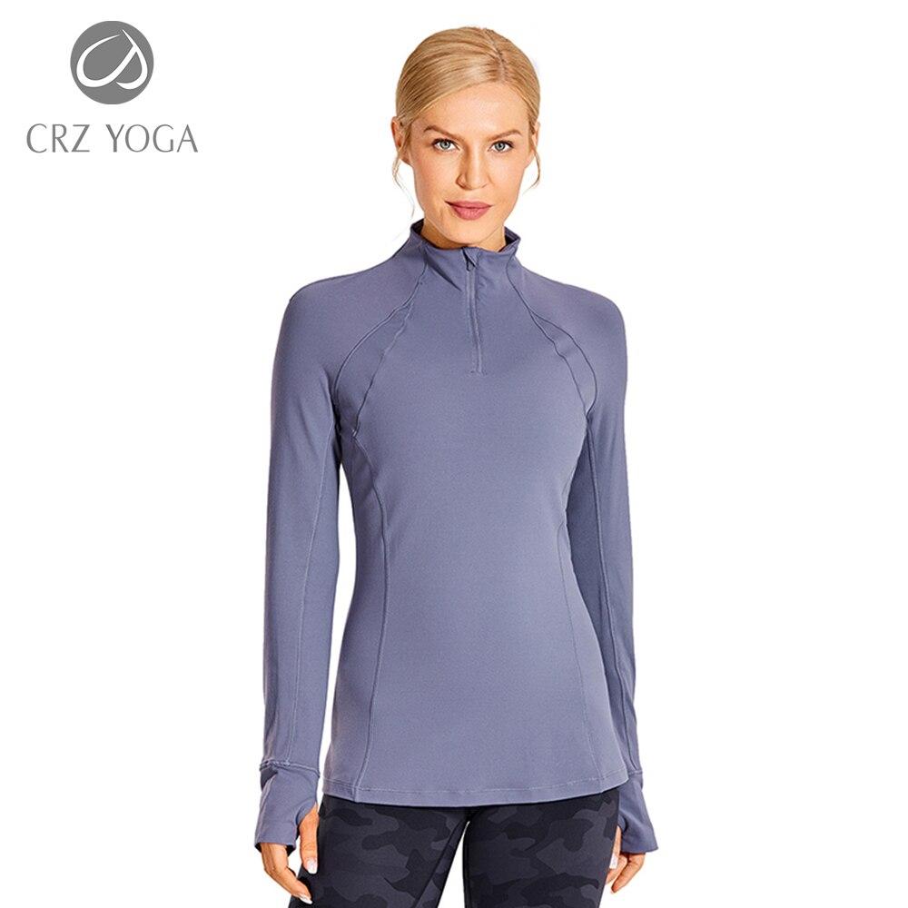 Women's long sleeve athletic workout shirt with quarter-zip design, perfect for running and yoga, made from breathable polyester blend.