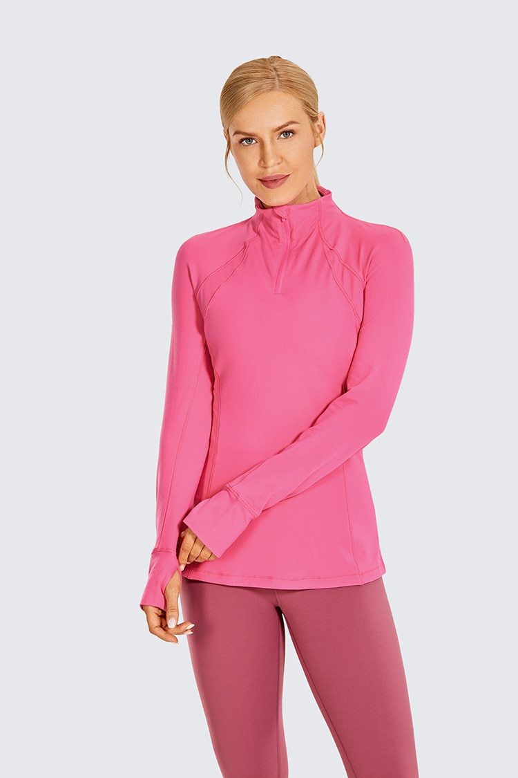 Women's long sleeve athletic workout shirt with quarter-zip design, perfect for running and yoga, made from breathable polyester blend.