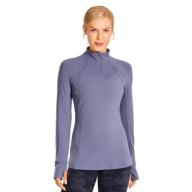 Women's long sleeve athletic workout shirt with quarter-zip design, perfect for running and yoga, made from breathable polyester blend.