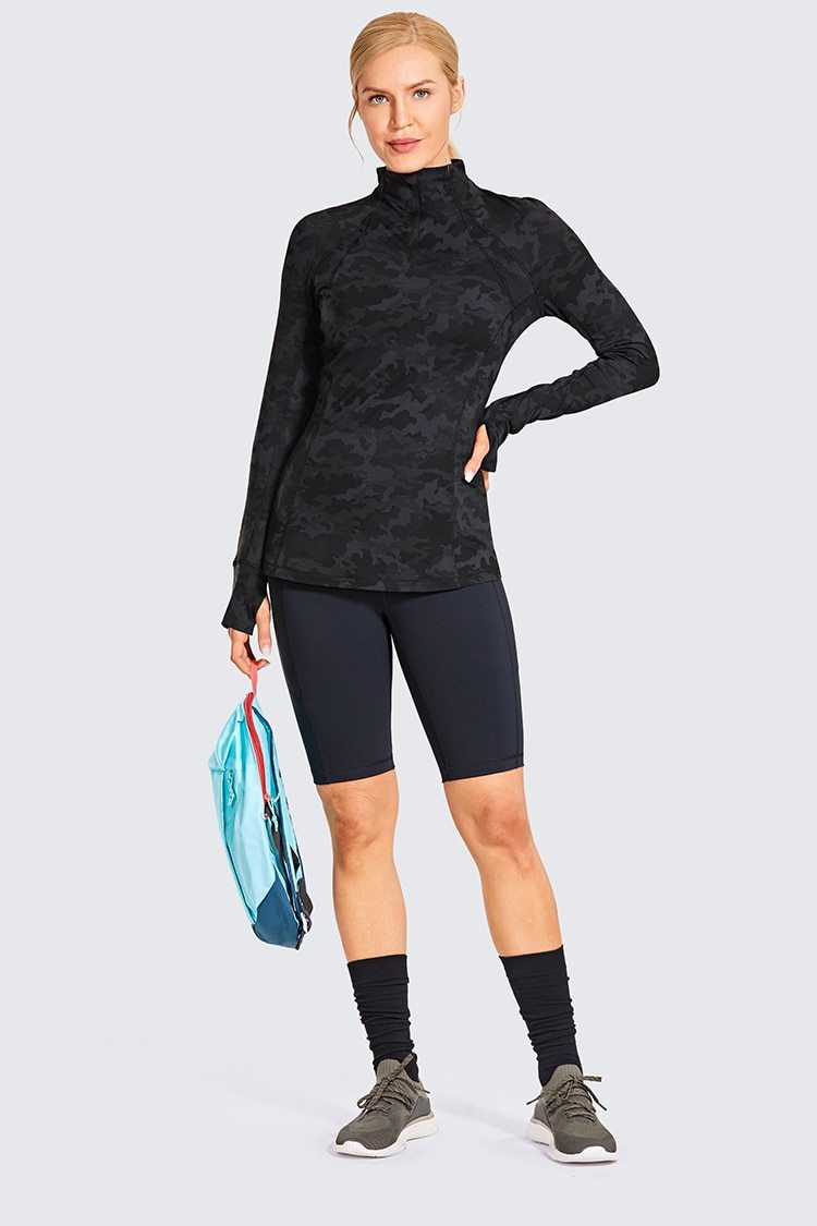 Women's long sleeve athletic workout shirt with quarter-zip design, perfect for running and yoga, made from breathable polyester blend.