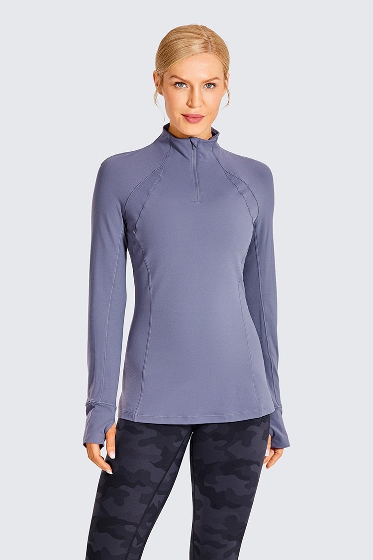 Women's long sleeve athletic workout shirt with quarter-zip design, perfect for running and yoga, made from breathable polyester blend.