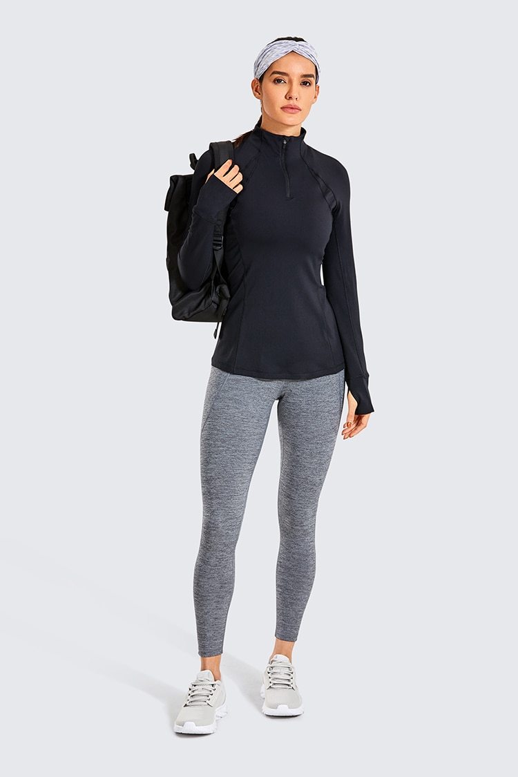 Women's long sleeve athletic workout shirt with quarter-zip design, perfect for running and yoga, made from breathable polyester blend.