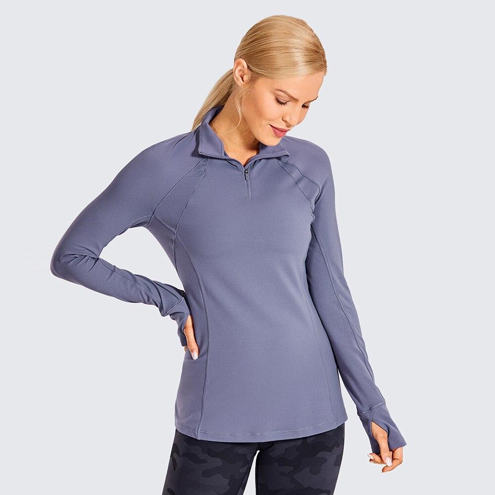 Women's long sleeve athletic workout shirt with quarter-zip design, perfect for running and yoga, made from breathable polyester blend.