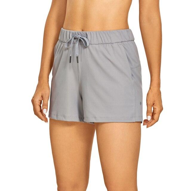 Women's Stretch Lightweight Athletic Shorts featuring an elastic waist and drawstring, perfect for workouts and travel, with pockets for convenience.