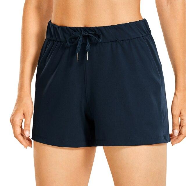 Women's Stretch Lightweight Athletic Shorts featuring an elastic waist and drawstring, perfect for workouts and travel, with pockets for convenience.