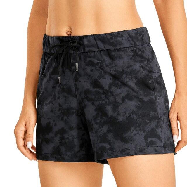 Women's Stretch Lightweight Athletic Shorts featuring an elastic waist and drawstring, perfect for workouts and travel, with pockets for convenience.