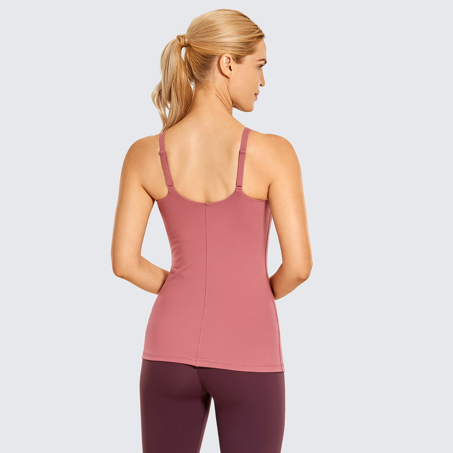 A stylish women's workout tank top featuring adjustable spaghetti straps and a built-in bra, perfect for yoga and athletic activities.