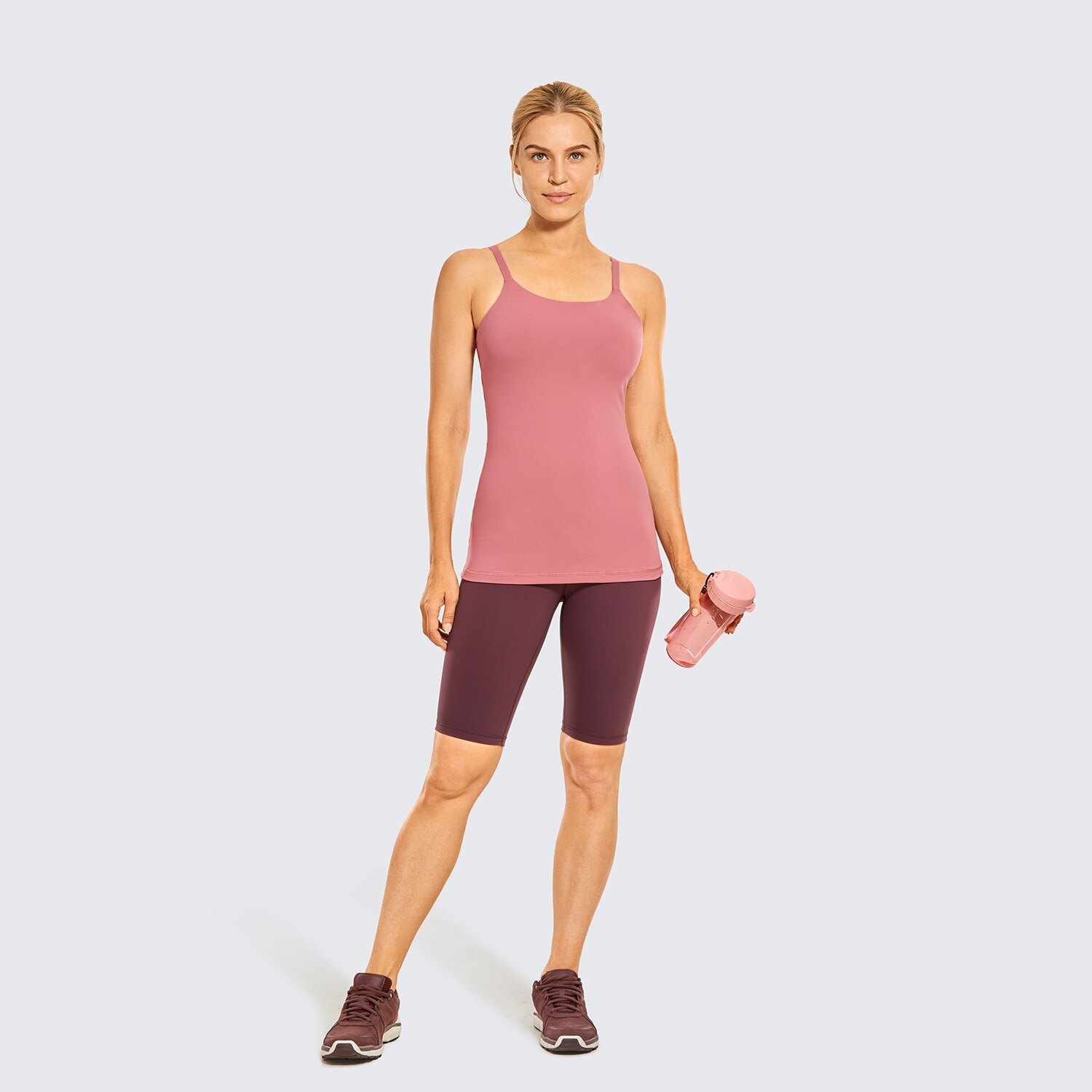 A stylish women's workout tank top featuring adjustable spaghetti straps and a built-in bra, perfect for yoga and athletic activities.