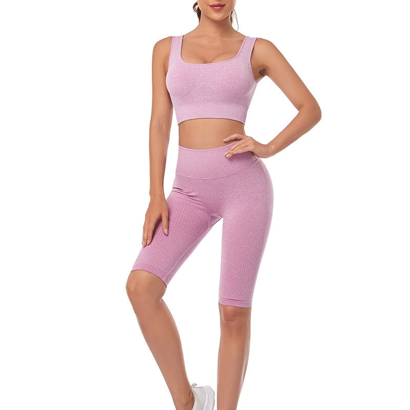 A stylish seamless yoga set for women, featuring leggings, a fitness bra, and a crop top in various colors including pink and black.