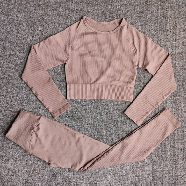 A stylish seamless yoga set for women, featuring leggings, a fitness bra, and a crop top in various colors including pink and black.