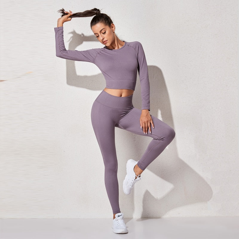 A stylish seamless yoga set for women, featuring leggings, a fitness bra, and a crop top in various colors including pink and black.