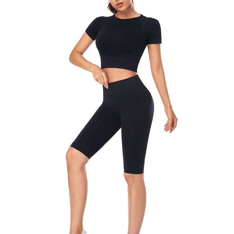 A stylish seamless yoga set for women, featuring leggings, a fitness bra, and a crop top in various colors including pink and black.