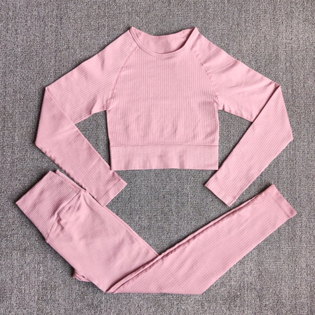 A stylish seamless yoga set for women, featuring leggings, a fitness bra, and a crop top in various colors including pink and black.