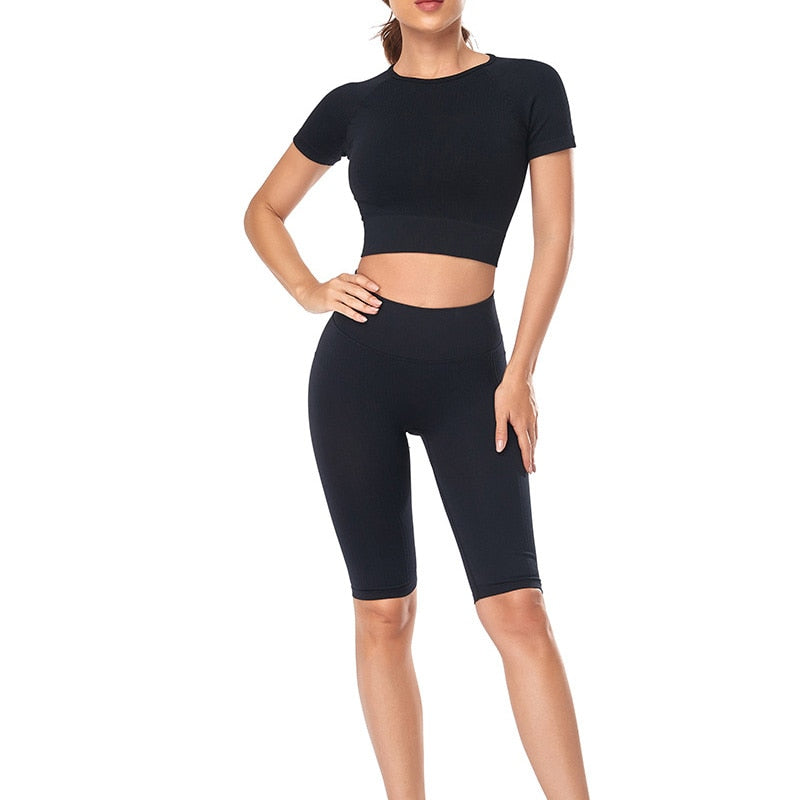 A stylish seamless yoga set for women, featuring leggings, a fitness bra, and a crop top in various colors including pink and black.