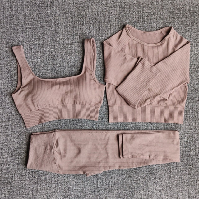 A stylish seamless yoga set for women, featuring leggings, a fitness bra, and a crop top in various colors including pink and black.