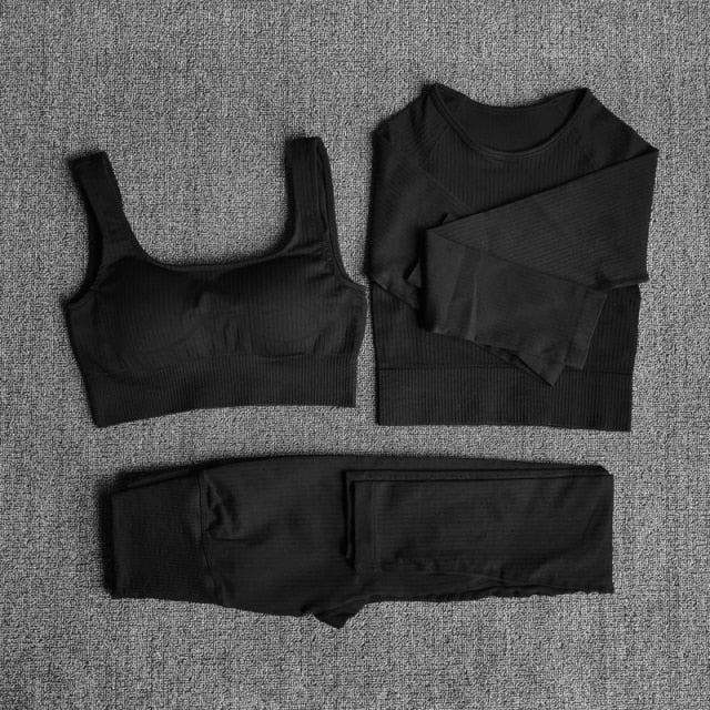 A stylish seamless yoga set for women, featuring leggings, a fitness bra, and a crop top in various colors including pink and black.