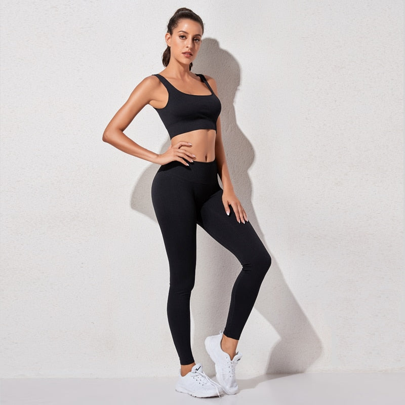 A stylish seamless yoga set for women, featuring leggings, a fitness bra, and a crop top in various colors including pink and black.