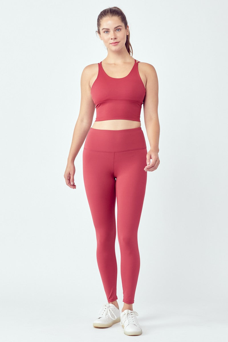 Woman in red workout attire.