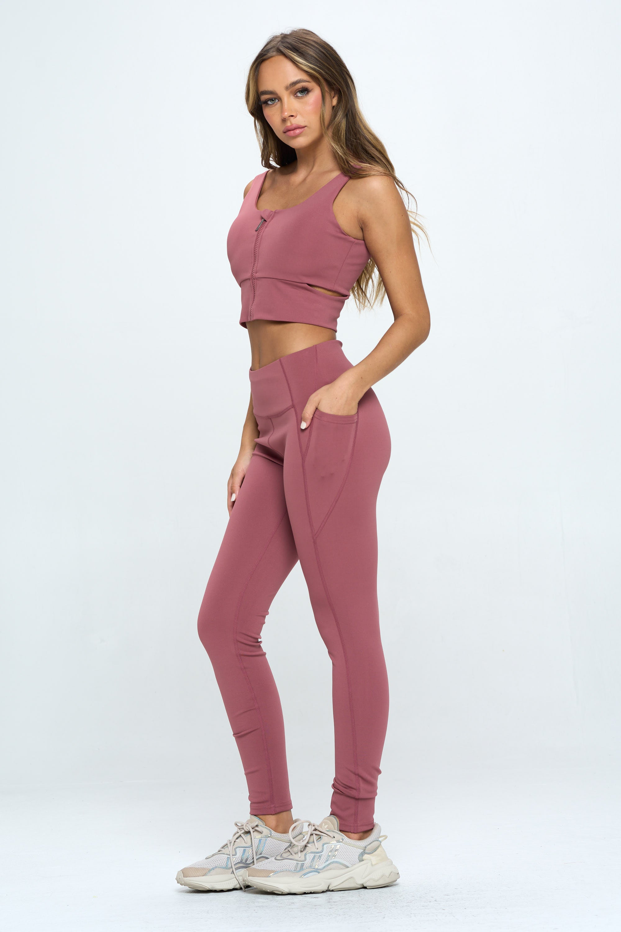 A stylish 2 Piece Zip Up Crop Sports Tank Top Set featuring a cropped tank and high waist biker shorts in multiple colors.