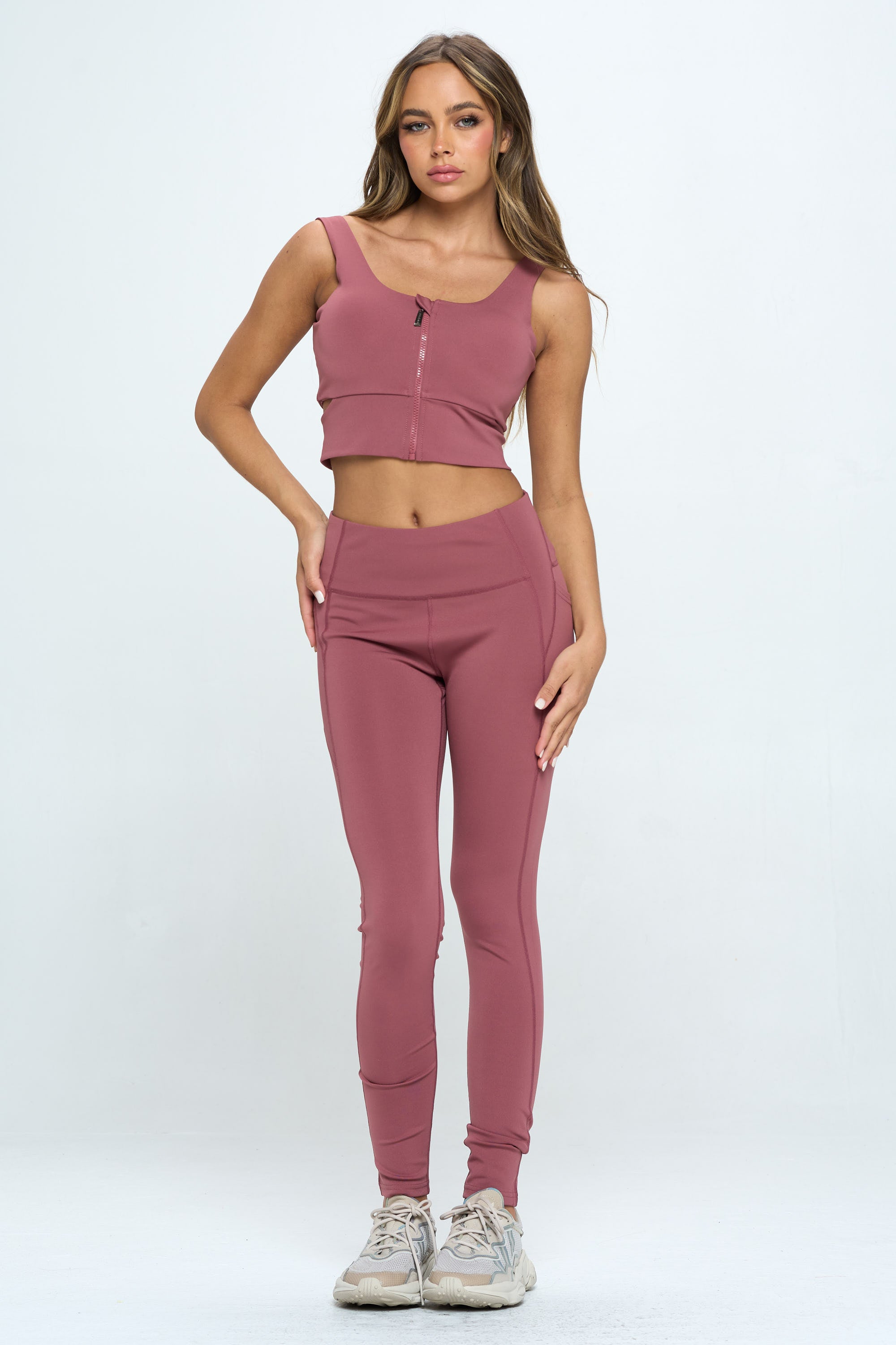 A stylish 2 Piece Zip Up Crop Sports Tank Top Set featuring a cropped tank and high waist biker shorts in multiple colors.