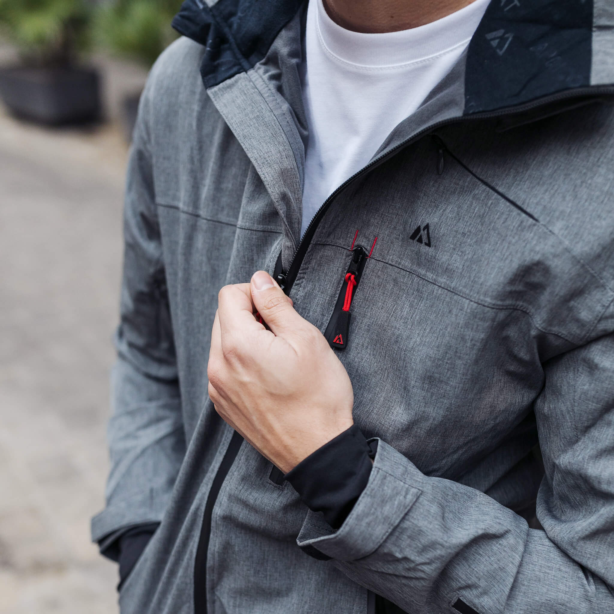 Adventure 2.0 Men Gray jacket featuring multiple pockets, waterproof fabric, and stylish design, ideal for outdoor activities.