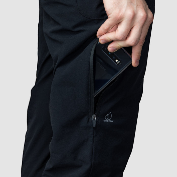 Men's black Adventure Pants featuring multiple pockets and a stylish design, perfect for outdoor activities.