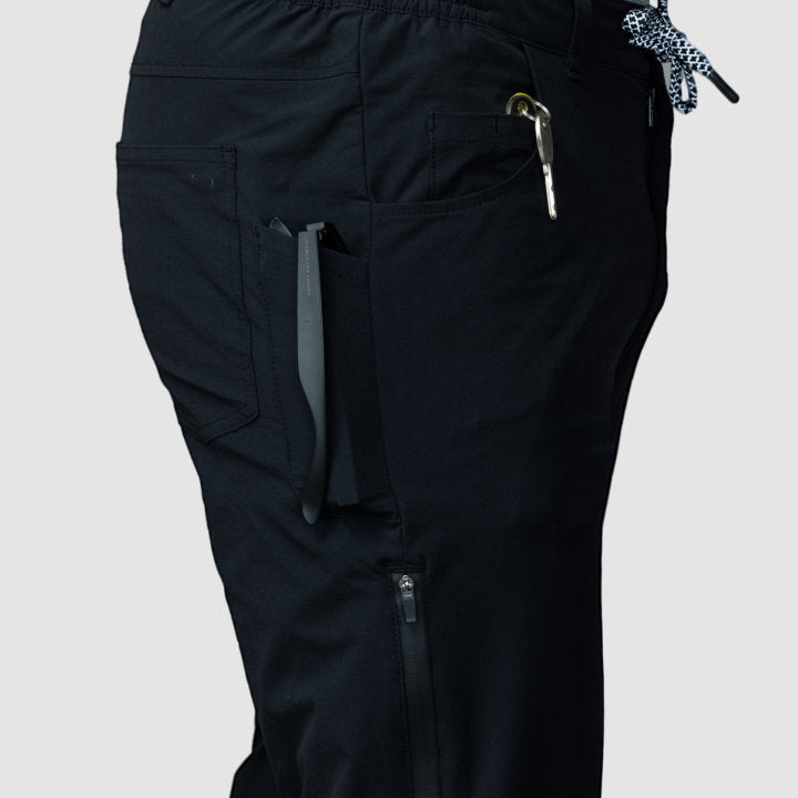 Men's black Adventure Pants featuring multiple pockets and a stylish design, perfect for outdoor activities.