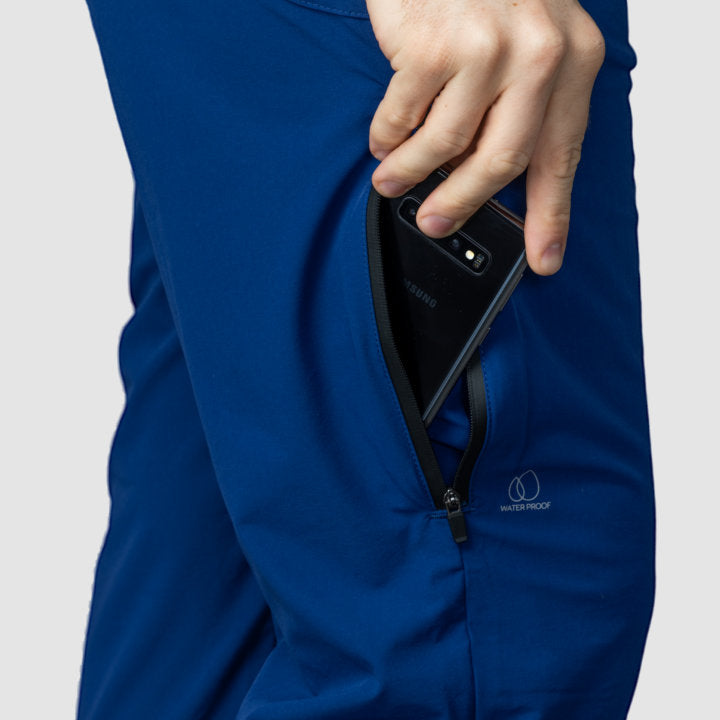 Men's navy blue Adventure Pants featuring multiple pockets and a stylish design, perfect for outdoor activities.