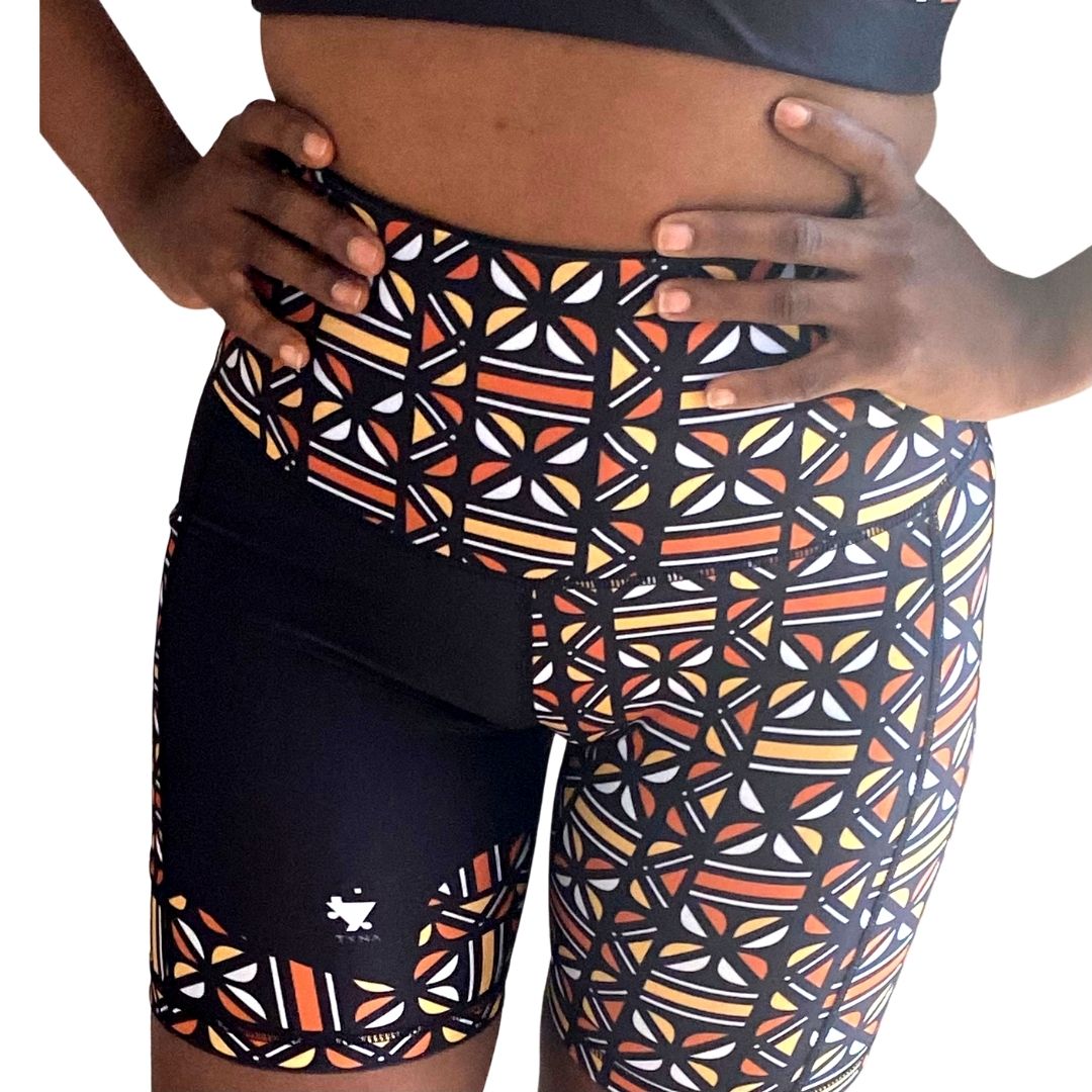 Adyre High Rise Biker Shorts featuring a vibrant Batik pattern, high waist design, and side pocket for phone storage.