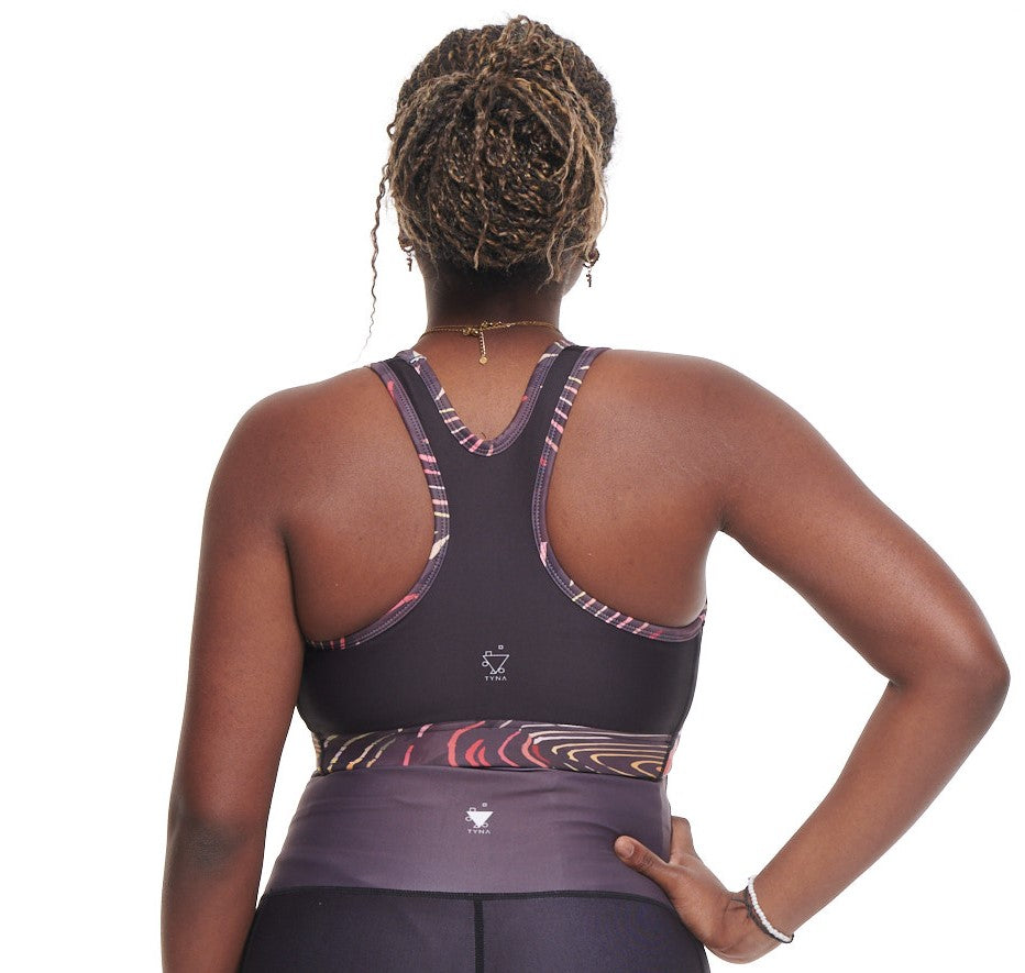 Adyre on Brocade Sports Bra featuring vibrant African prints in Green, Red, Black, and Grey with Burnt Orange and Yellow accents.