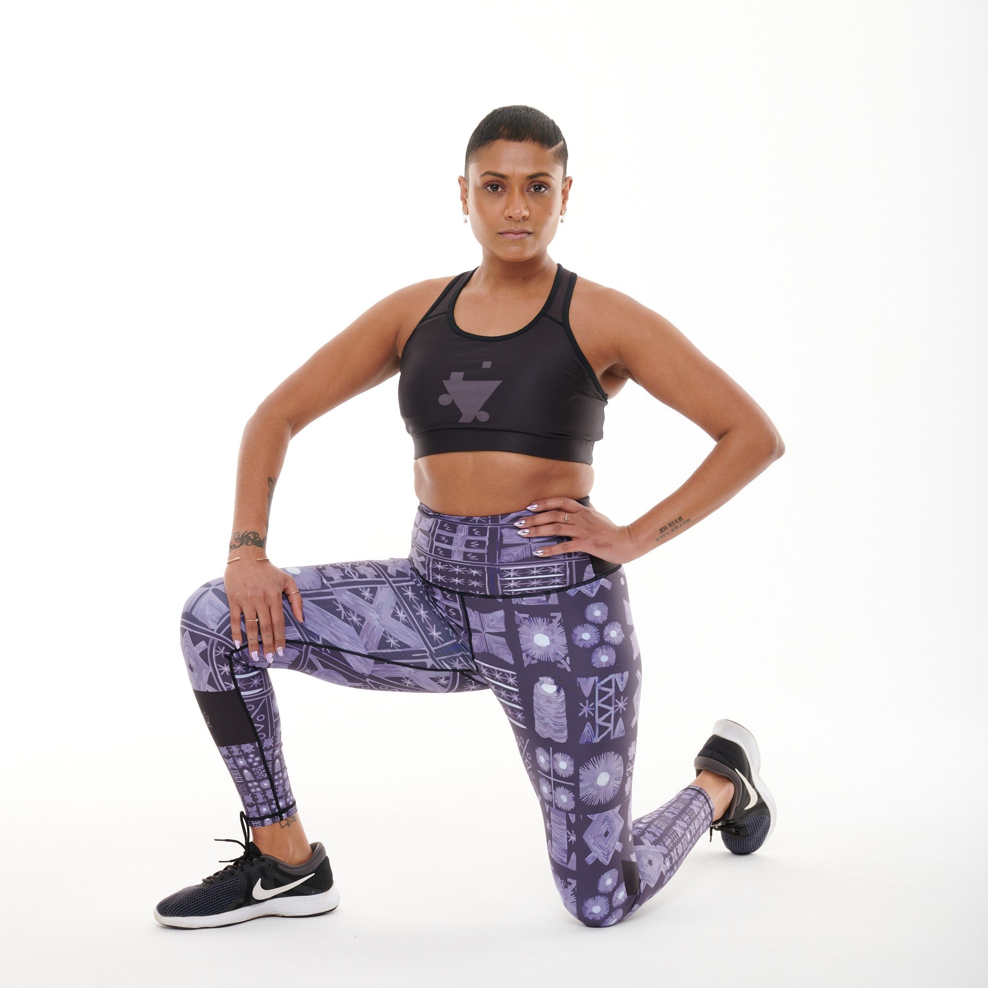 TYNA Adyre Vibrant Leggings featuring a colorful Adire print, designed for high performance with an engineered waistband and removable drawstring.