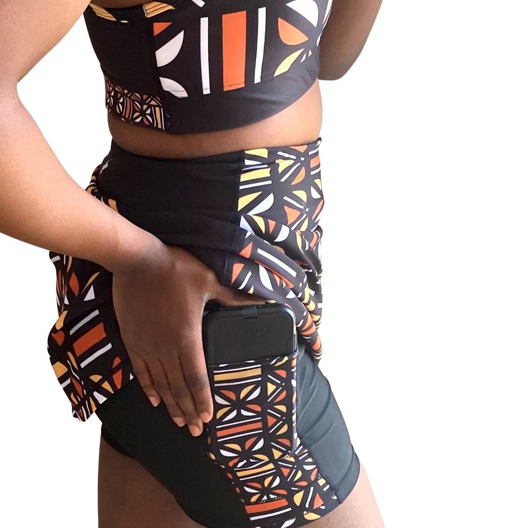 Batiq High Rise Tennis Skort featuring vibrant Batik print and compressive biker shorts underneath, designed for active lifestyles.