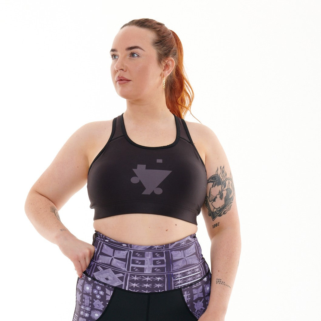 B.G.W.E Sports Bra in black, designed for comfort and style, featuring TYNA Logo and medium support for various activities.