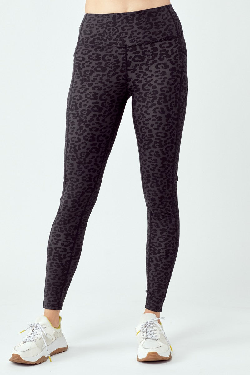 A pair of stylish black leopard leggings featuring a high waist and flat seams, perfect for workouts and casual wear.