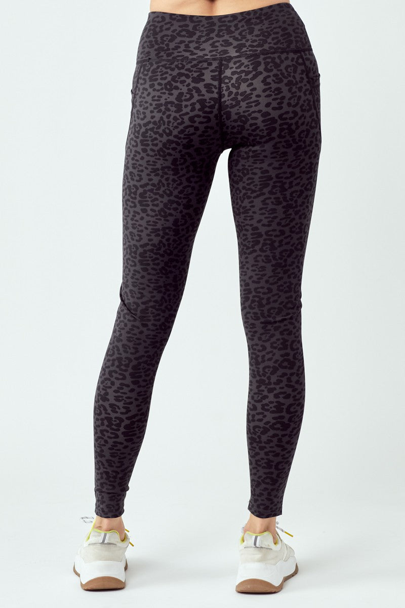 A pair of stylish black leopard leggings featuring a high waist and flat seams, perfect for workouts and casual wear.