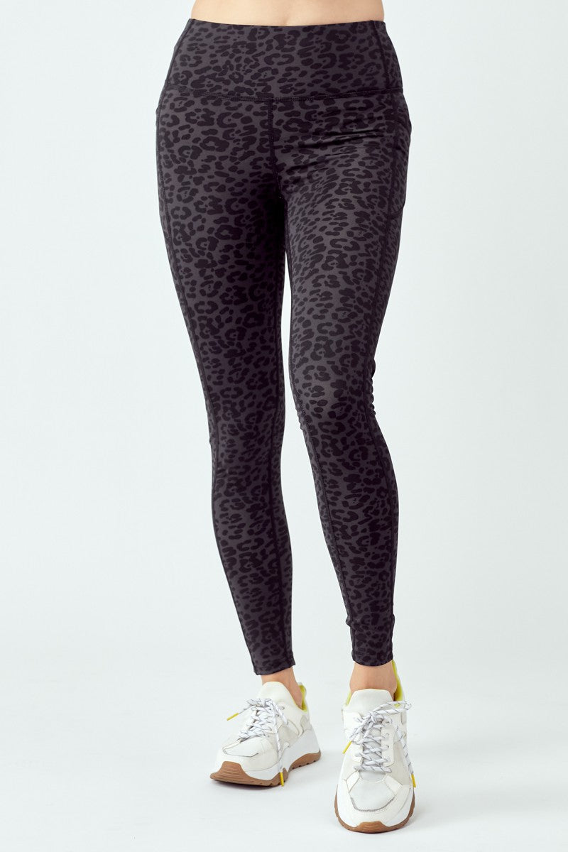 A pair of stylish black leopard leggings featuring a high waist and flat seams, perfect for workouts and casual wear.