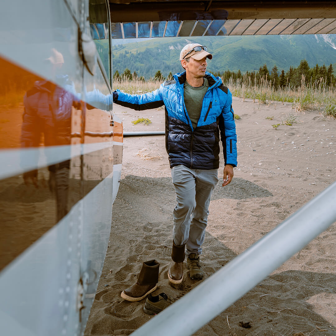 Men's EcoDown Jacket in blue, made from recycled materials, featuring a lightweight design and built-in sleeve gloves.