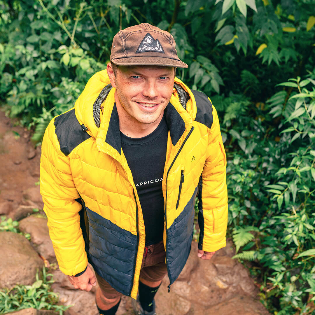 Men's EcoDown Jacket in yellow, made from recycled materials, featuring elastic hems and built-in sleeve gloves.