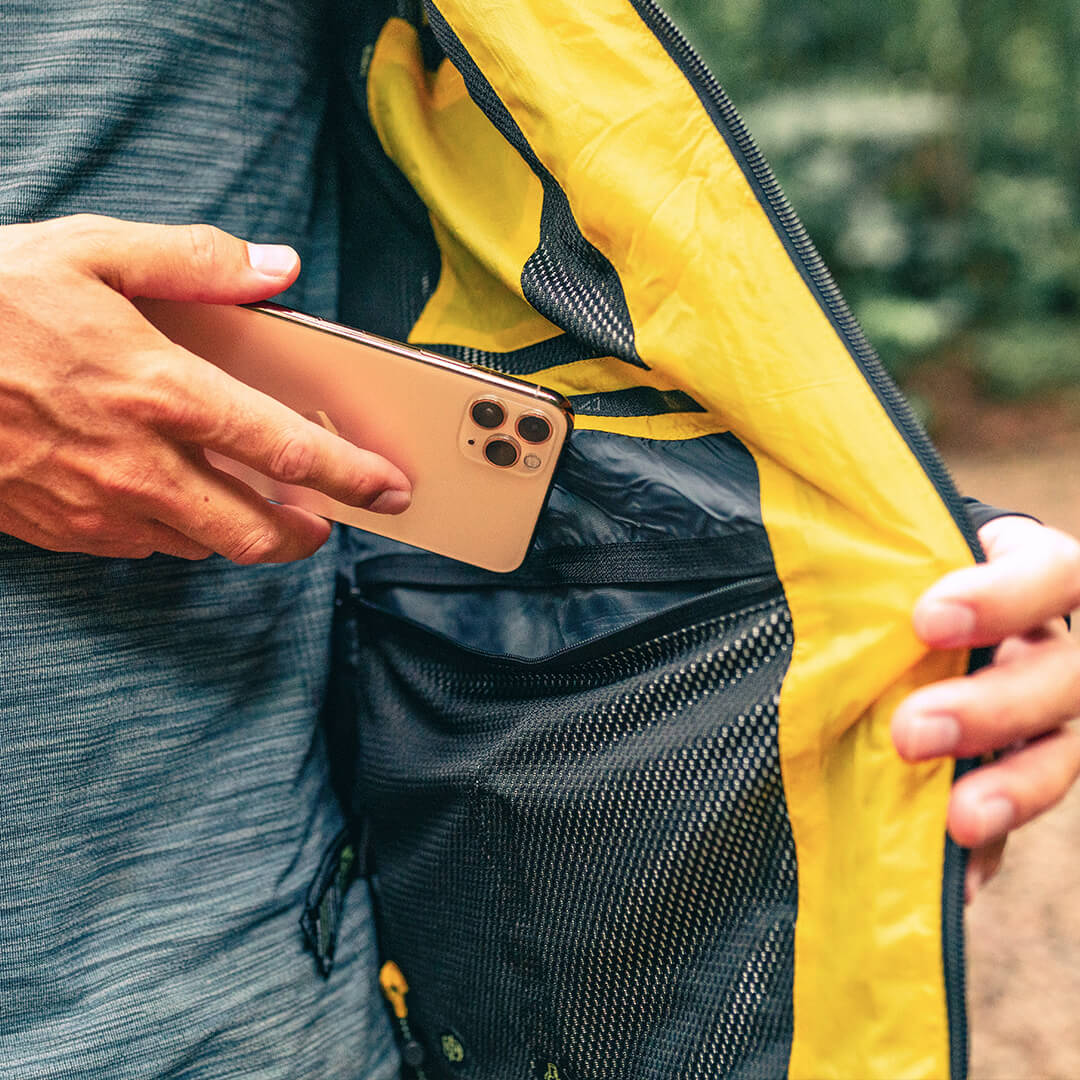 Men's EcoDown Jacket in yellow, made from recycled materials, featuring elastic hems and built-in sleeve gloves.