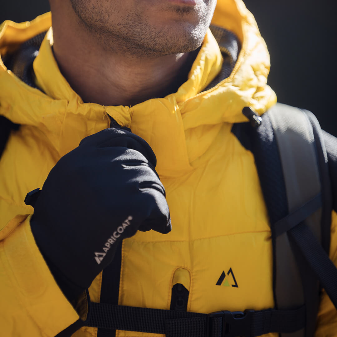 Men's EcoDown Jacket in yellow, made from recycled materials, featuring elastic hems and built-in sleeve gloves.