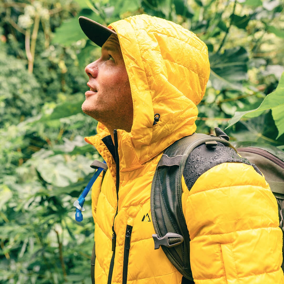 Men's EcoDown Jacket in yellow, made from recycled materials, featuring elastic hems and built-in sleeve gloves.